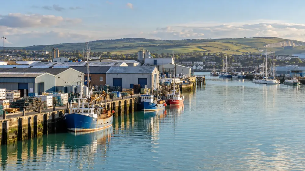 Commercial harbour buildings and moored boats on the Sussex coast